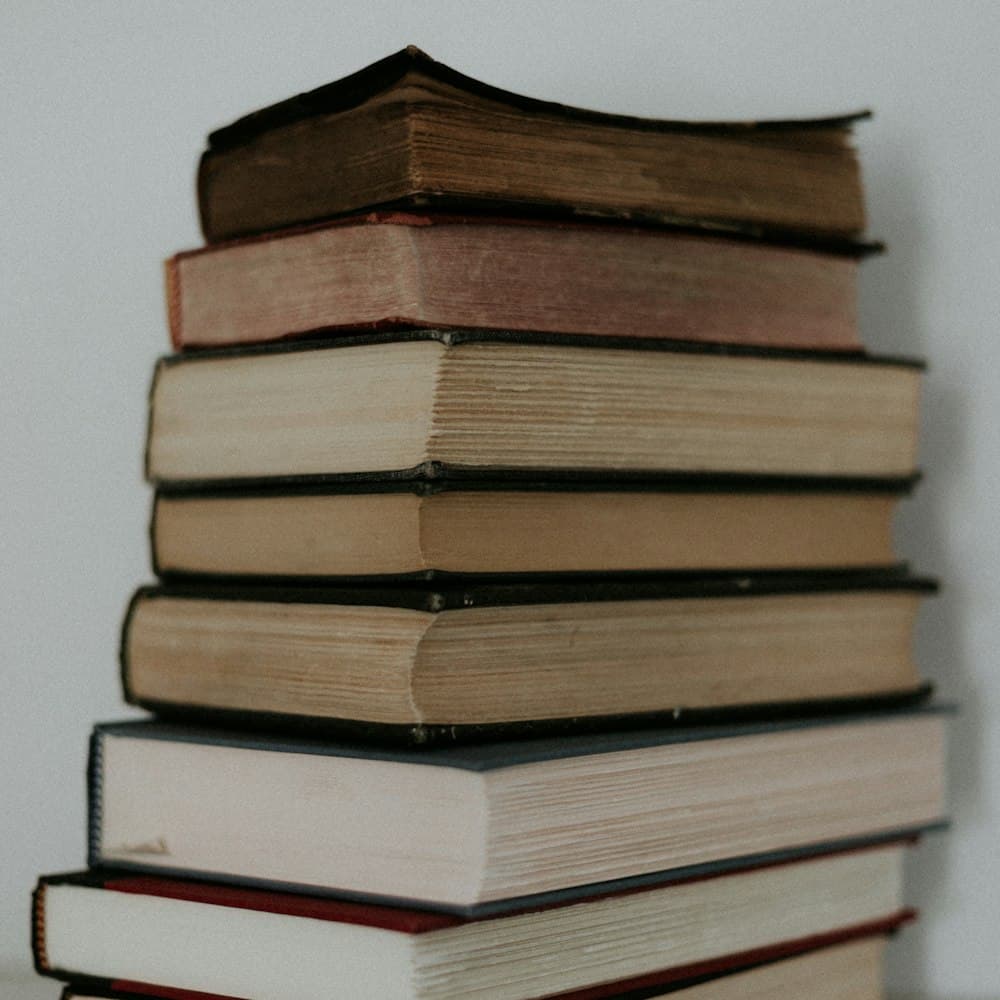 A stack of hardcover books — placeholder imagery standing in for the Livin' On a Chair cover
