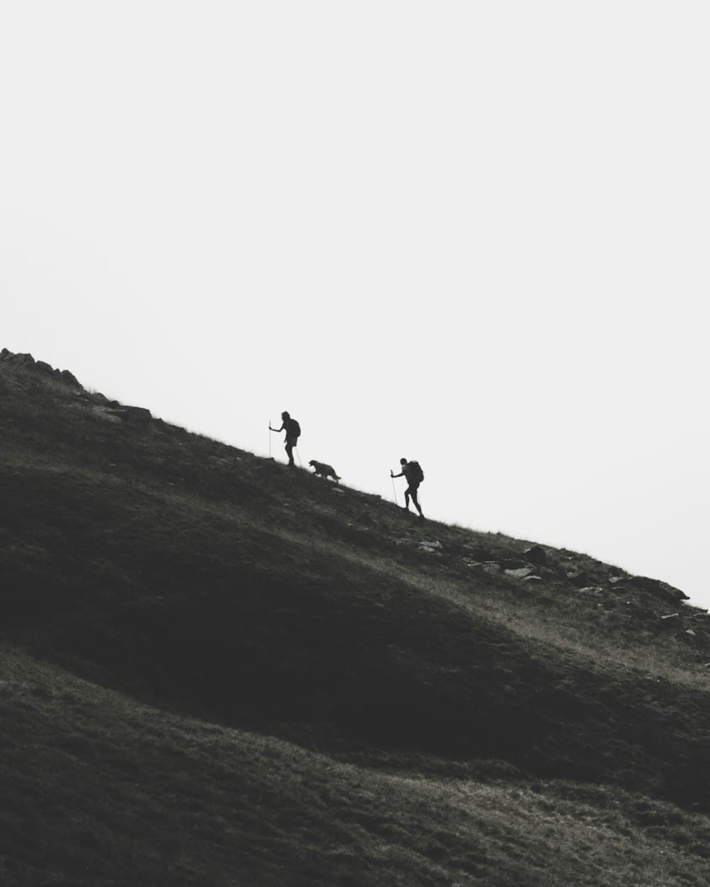 Two hikers pressing forward up a mountain trail at dusk — placeholder imagery, standing in for Scott's own photography